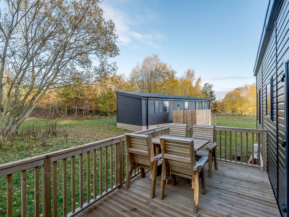 An outdoor deck with wooden furniture at Horncastle Plus (Pet) Louth