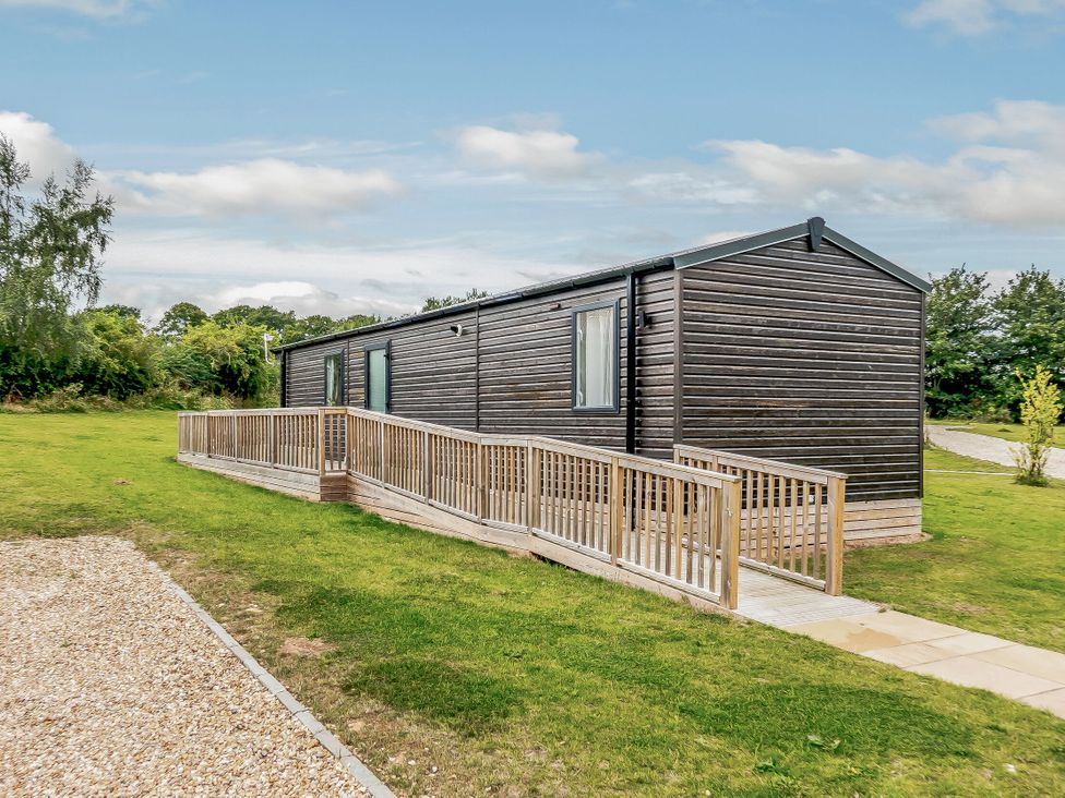 A cabin with a ramp and green grass at Alford WF in Louth