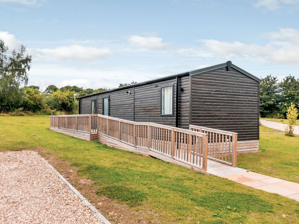 A cabin with decking on the side at Alford WF in Louth