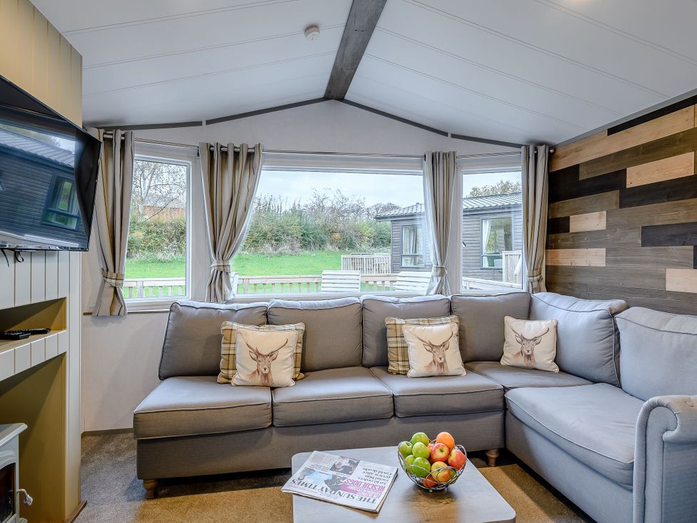 A snug with a sofa, television, and coffee table at Alford WF in Louth