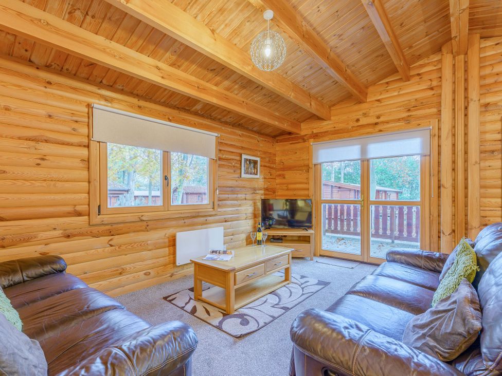 A living room with a sofa and coffee table at Cedar Lodge in Louth