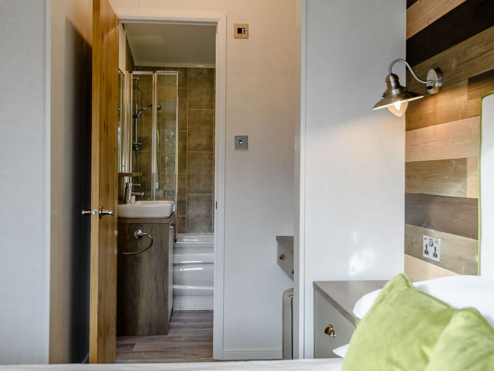 A bathroom with a shower and sink at Elsham Lodge in Louth