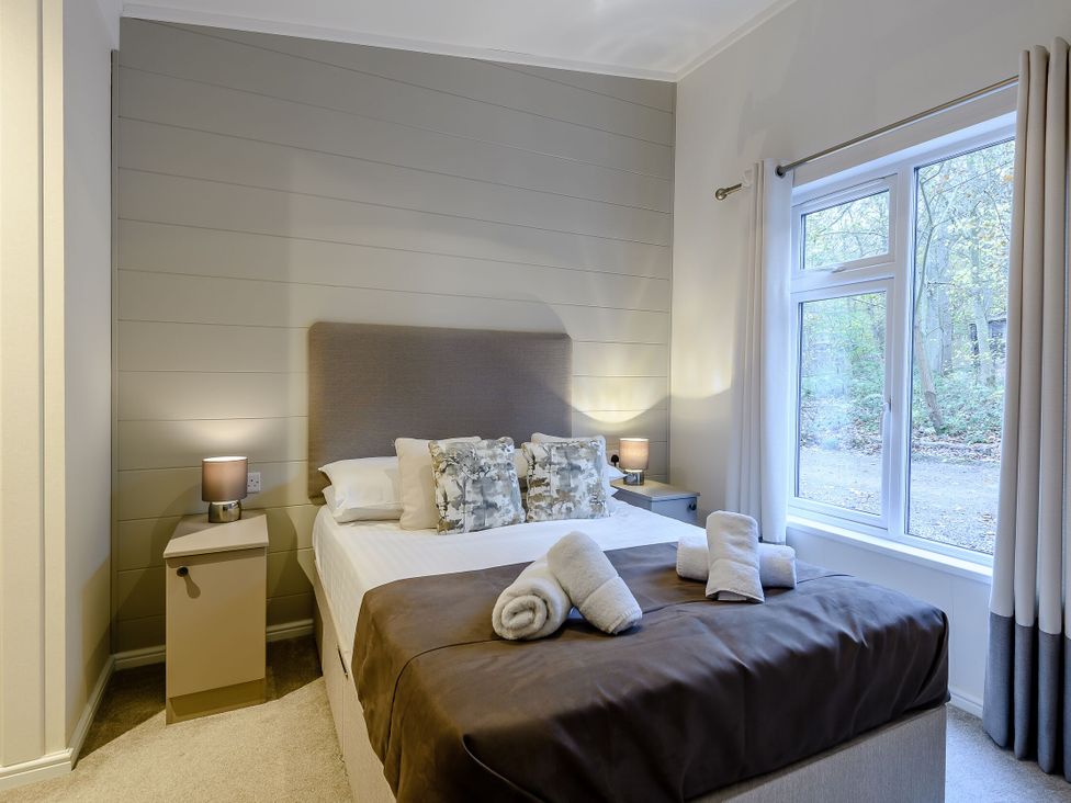 A bedroom with a bed and nightstand at Stamford Spa in Louth