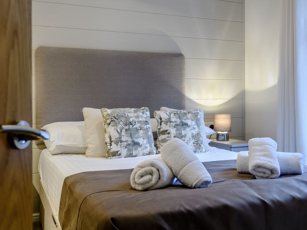 A bedroom with a bed and bedside table at Stamford Spa in Louth