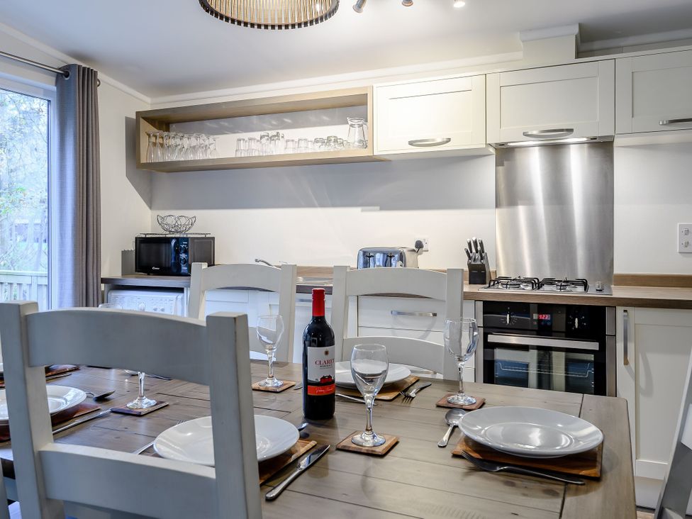 A kitchen with a dining area and appliances at Stamford Spa in Louth