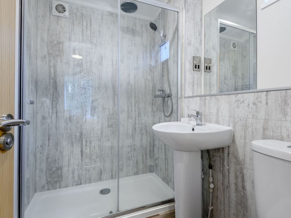 A bathroom with a shower and sink at Stamford Spa (Pet) in Louth
