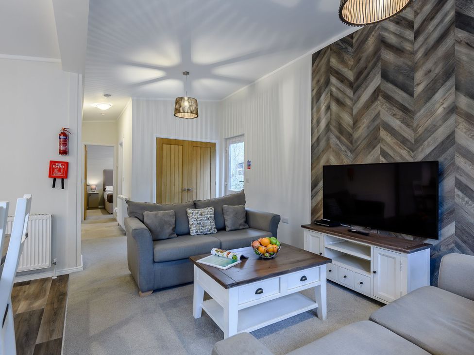 A living room with a sofa and television at Stamford Spa (Pet) Louth