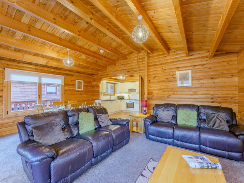 A living room with a sofa and a table at Cedar Lodge (Pet) in Louth