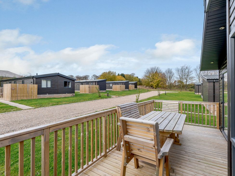 A deck area with a table and chairs at Elsham Lodge (Pet) Louth