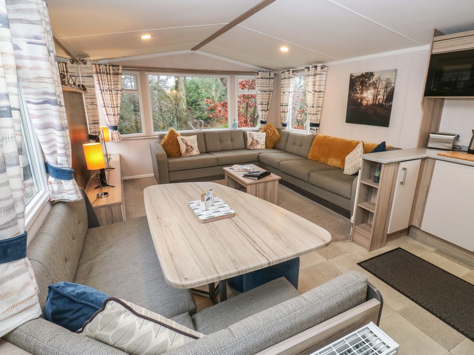A living room with sofas and a coffee table at Woodland View