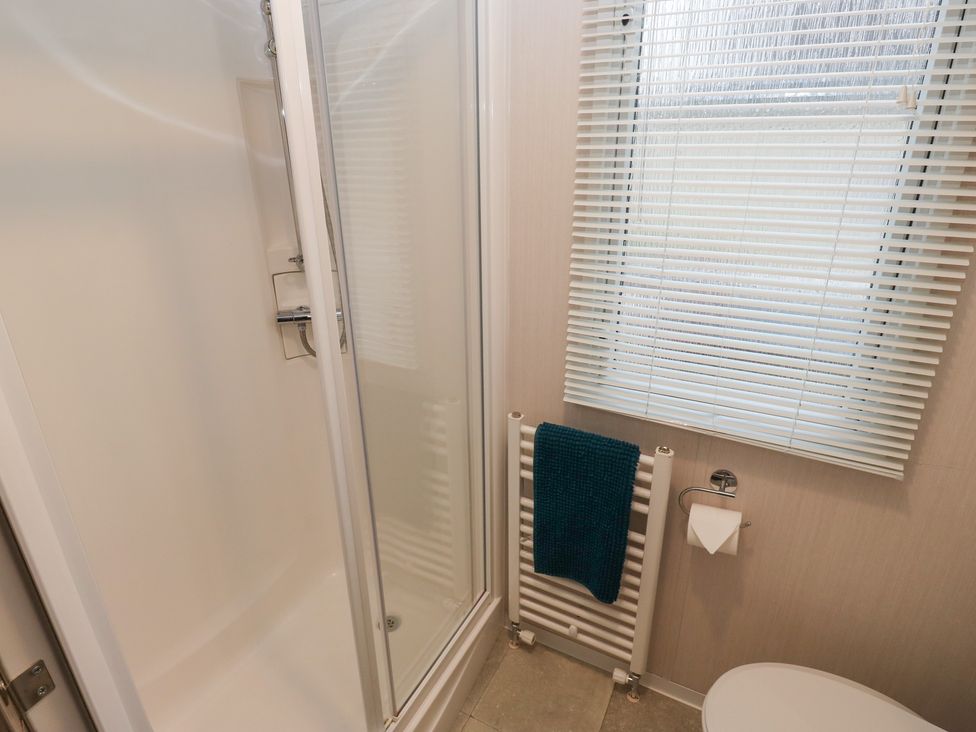 A bathroom with a shower and toilet at Woodland View