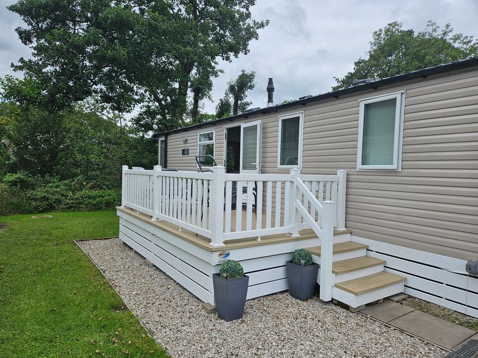 A holiday home with a deck and steps at Woodland View