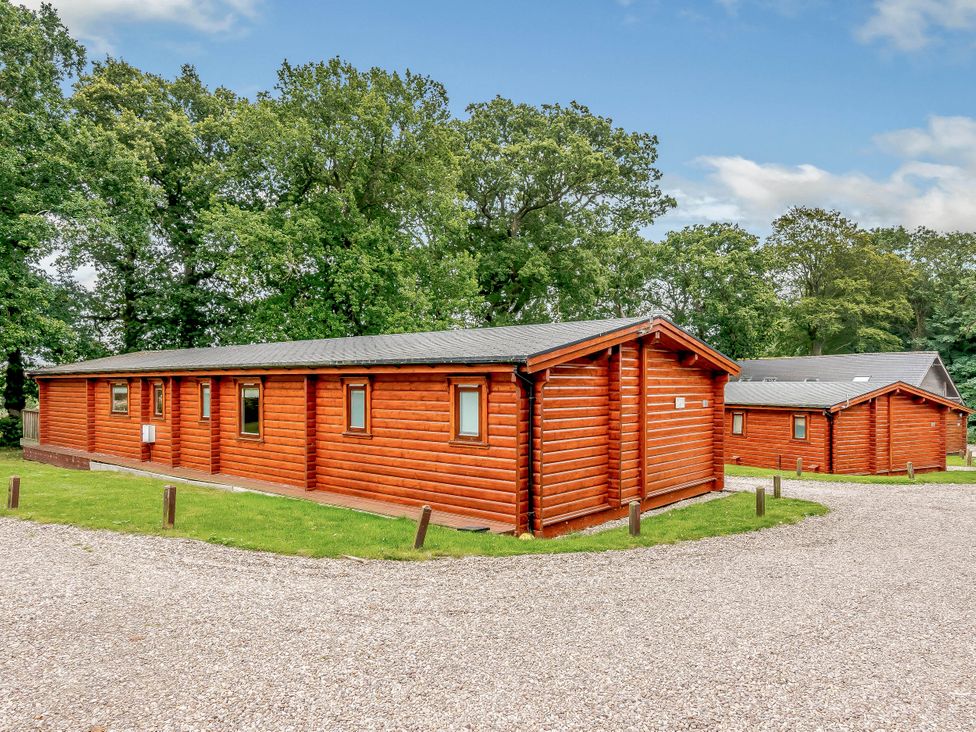 Log cabins surrounded by trees at Hazel Lodge in Louth