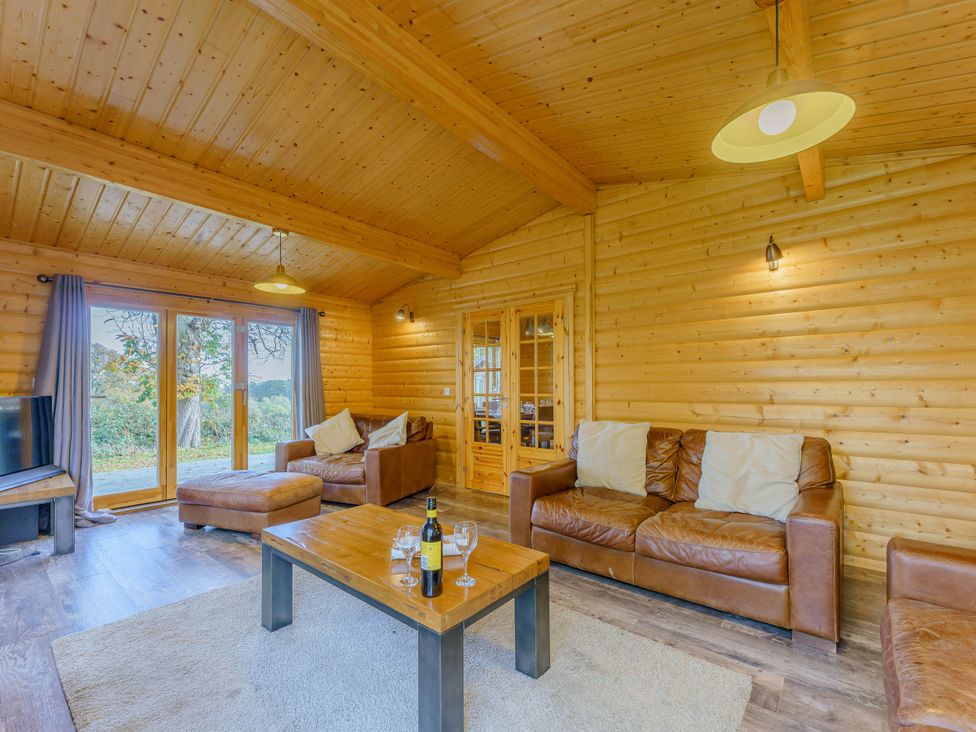 A living room with a sofa and coffee table at Hazel Lodge in Louth