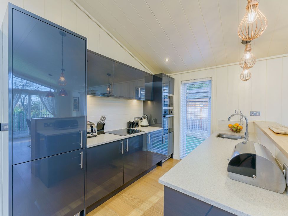 A kitchen with modern appliances and a fruit bowl at Retreat Lodge 4 in Louth