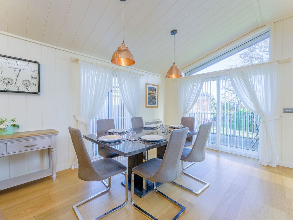 A dining room with a table and chairs at Retreat Lodge 4 in Louth