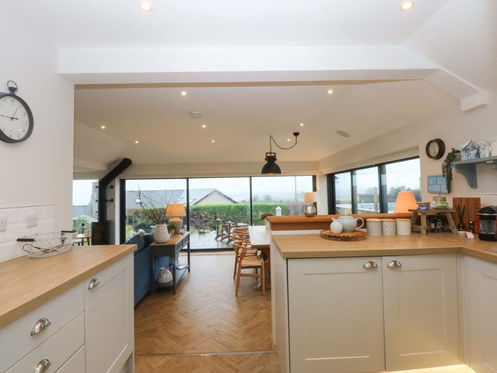 A kitchen with a view of the garden at Bryn Mor Cottage Mynytho near Llanbedrog