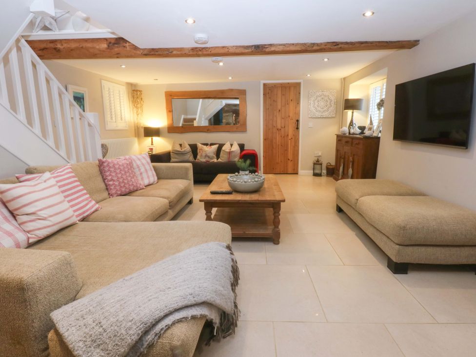 A living room with sofas and a coffee table at Bryn Mor Cottage in Mynytho near Llanbedrog