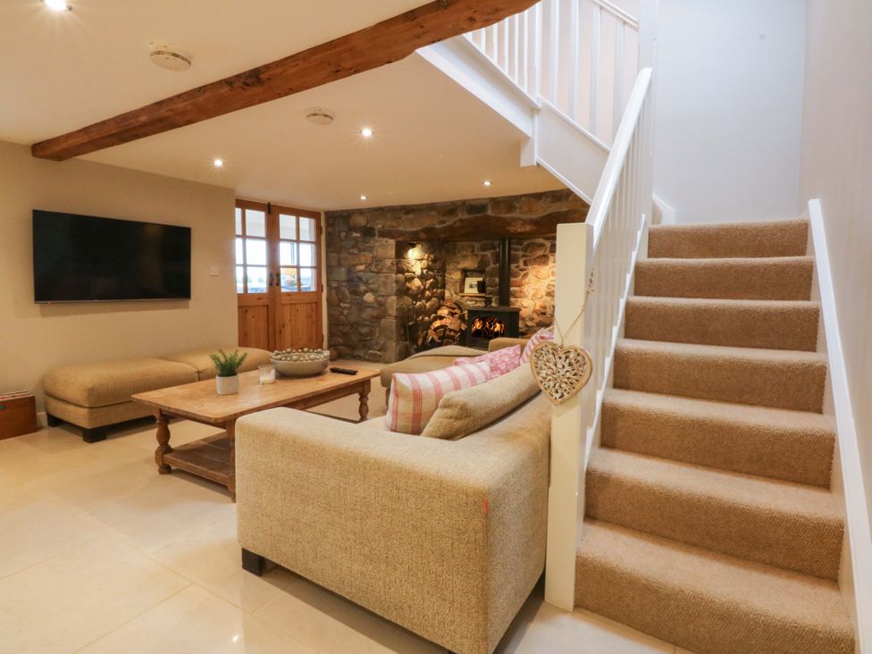 A living room with a sofa and coffee table at Bryn Mor Cottage Mynytho near Llanbedrog