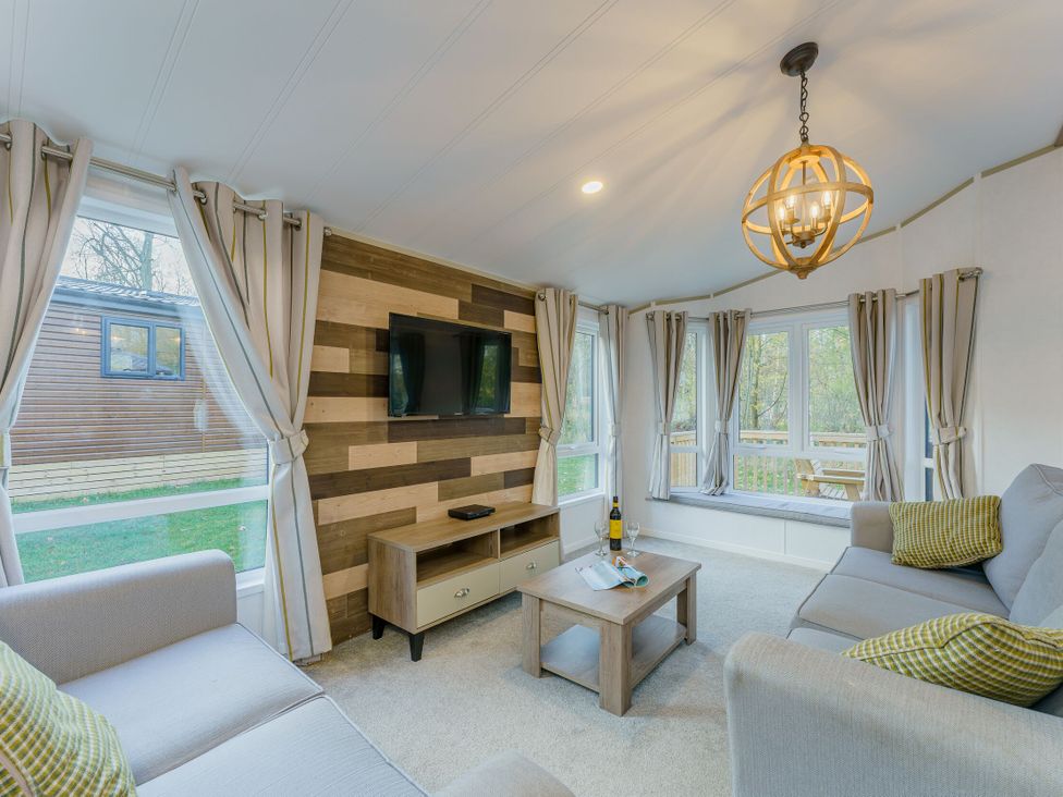 A living room with a TV and coffee table at Brayford Lodge Spa Louth