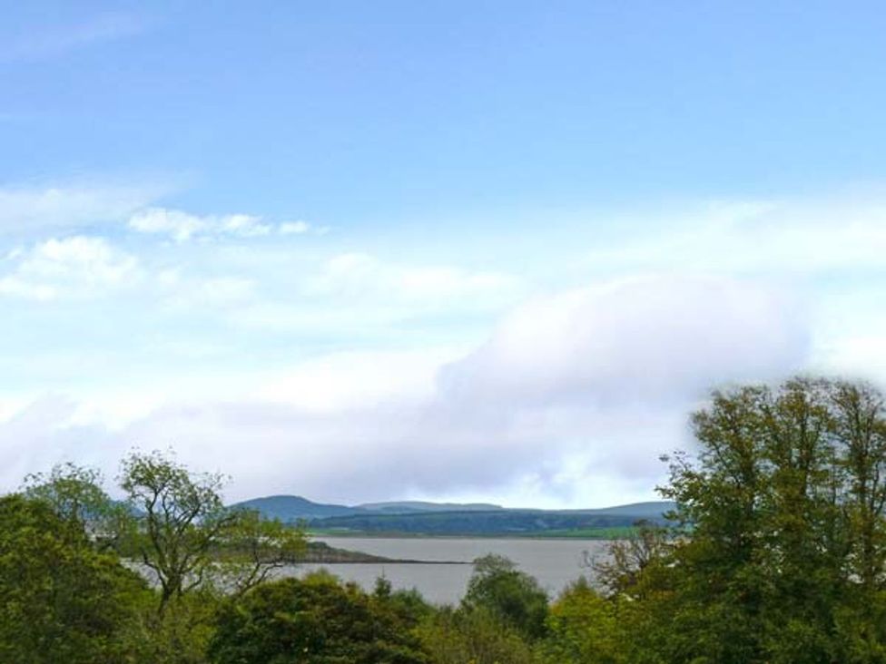 A view of water and hills with trees at Priory View in Ulverston