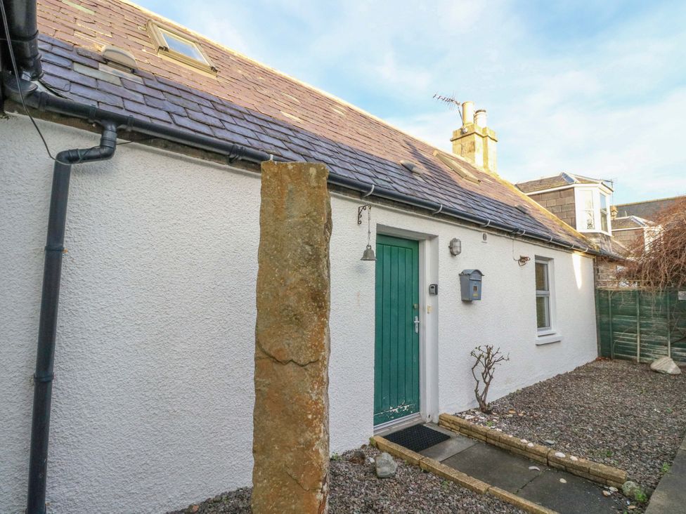 An entrance with a green door and a stone pillar at 78 Findhorn, Forres