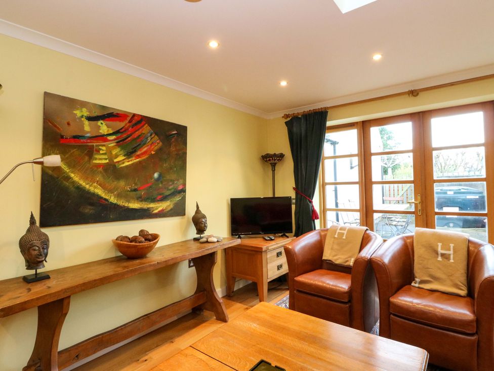 A living room with a painting and wooden furniture at 78 Findhorn in Forres