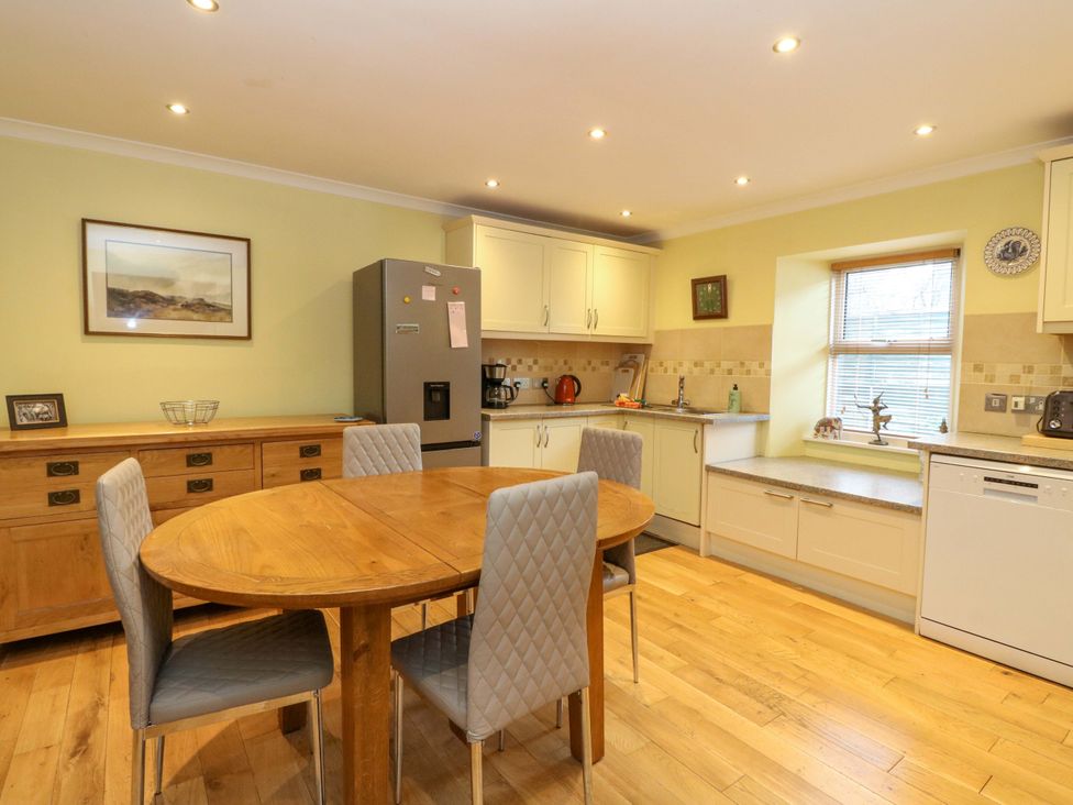 A kitchen with a table and chairs at 78 Findhorn in Forres
