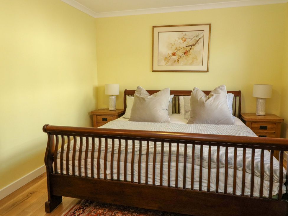 A bedroom with a bed and nightstands at 78 Findhorn in Forres