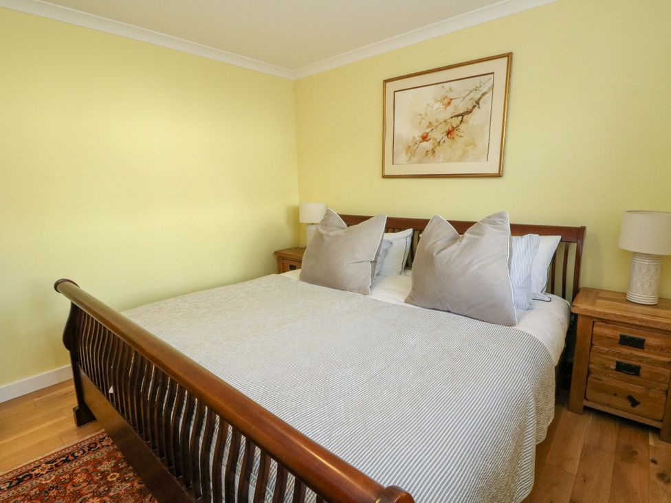 A bedroom with a bed and nightstands at 78 Findhorn in Forres