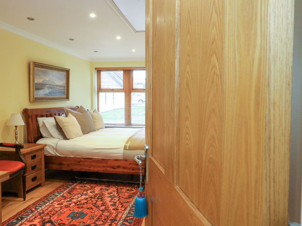 A bedroom with a bed and nightstand at 78 Findhorn in Forres