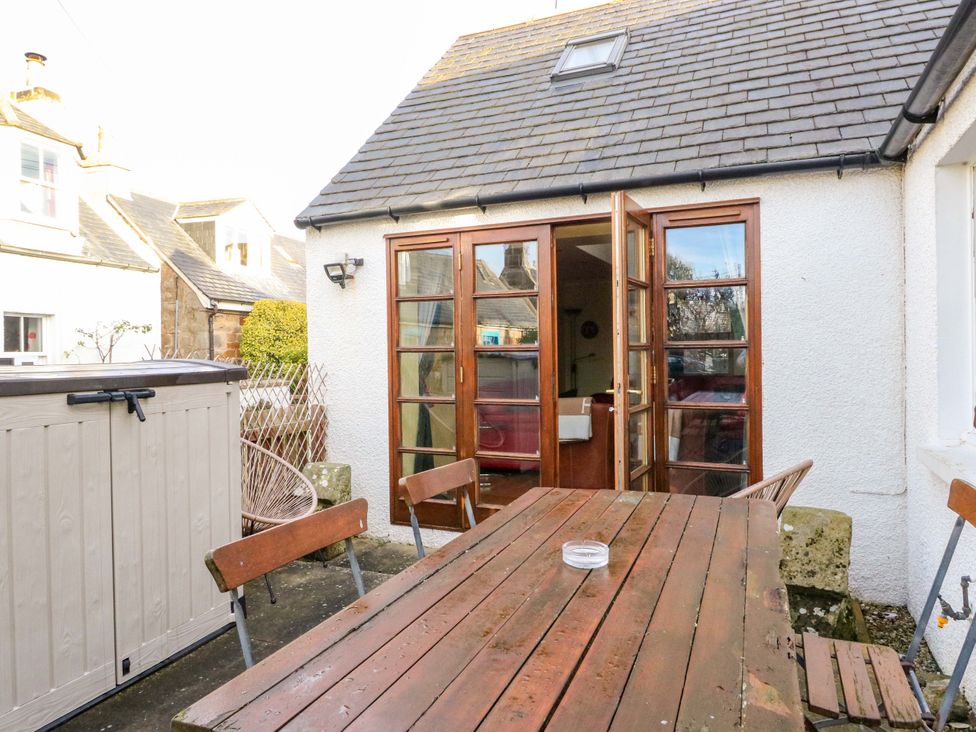 An outdoor area with a table and chairs at 78 Findhorn in Forres