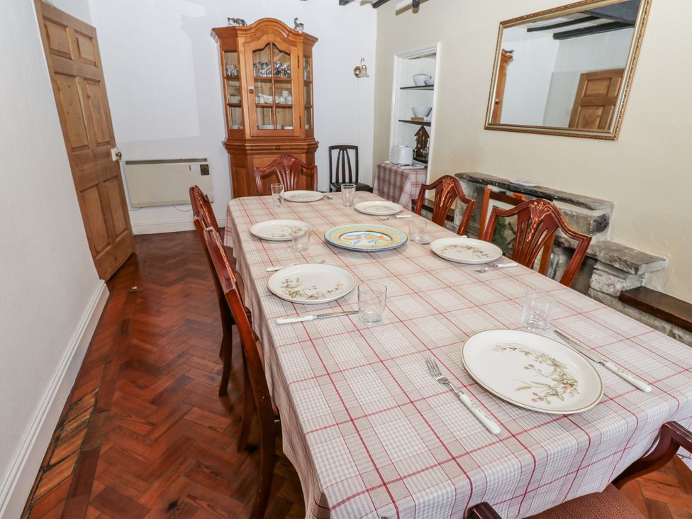 A dining room with a table set for dinner at Ivy Cottage in West Burton