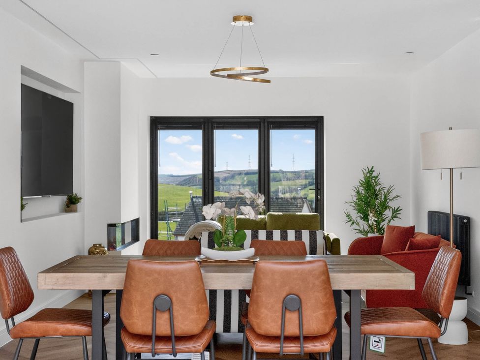 A dining room with a table and chairs at Heddfan in Carmarthen