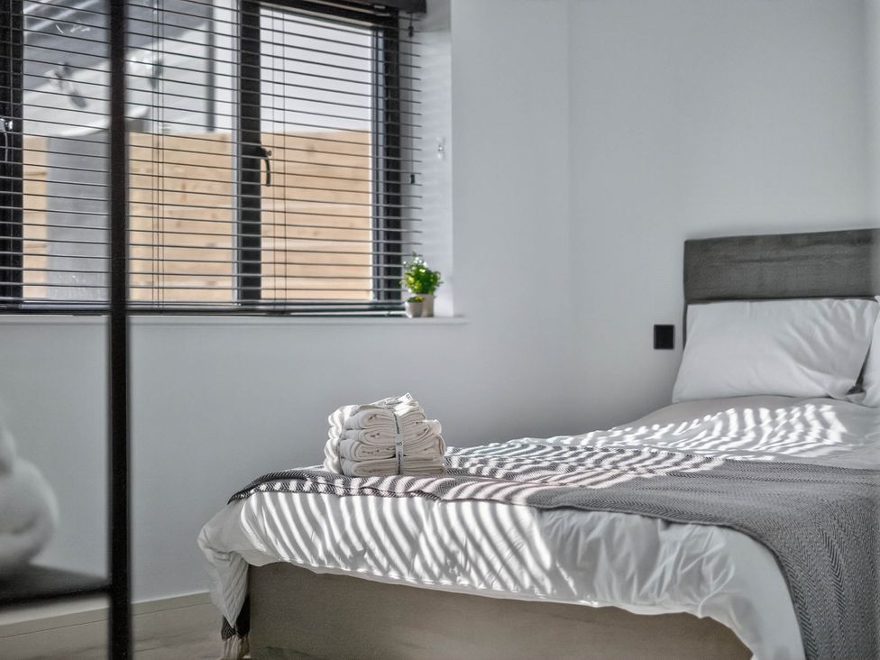 A bedroom with a bed and towels on it at Heddfan in Carmarthen