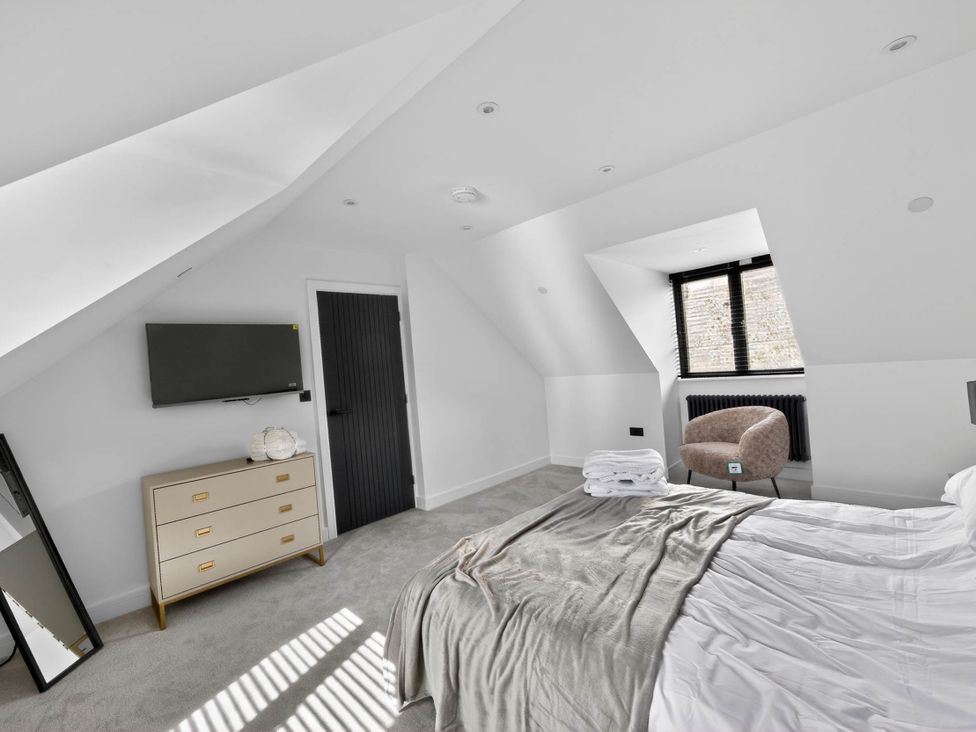 A bedroom with a bed and a television at Heddfan in Carmarthen