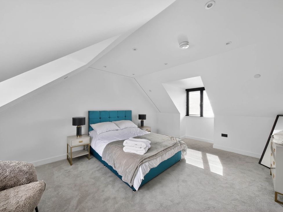 A bedroom with a bed and bedside table at Heddfan in Carmarthen