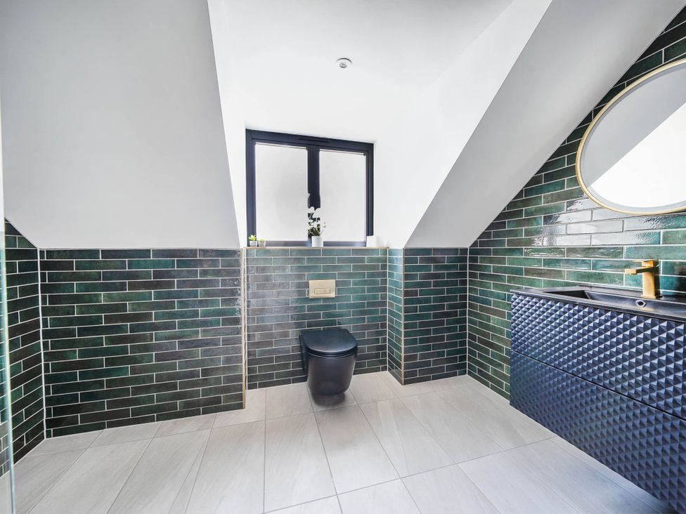 A bathroom with a toilet and sink at Heddfan in Carmarthen