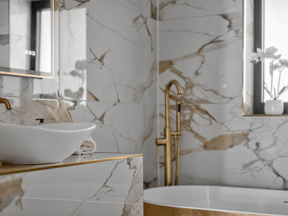 A bathroom with a sink and bathtub at Heddfan in Carmarthen