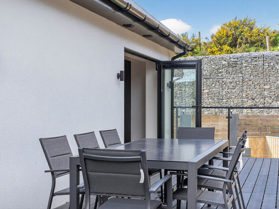 An outdoor space with a table and chairs at Heddfan in Carmarthen