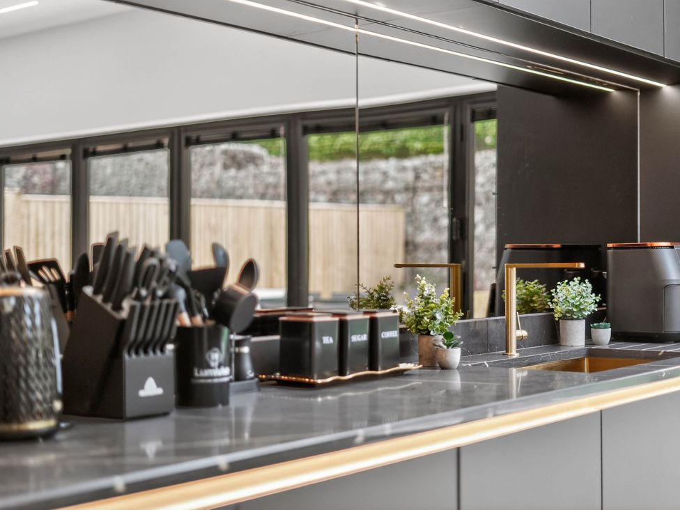 A kitchen with a sink and utensils at Ty Uchel