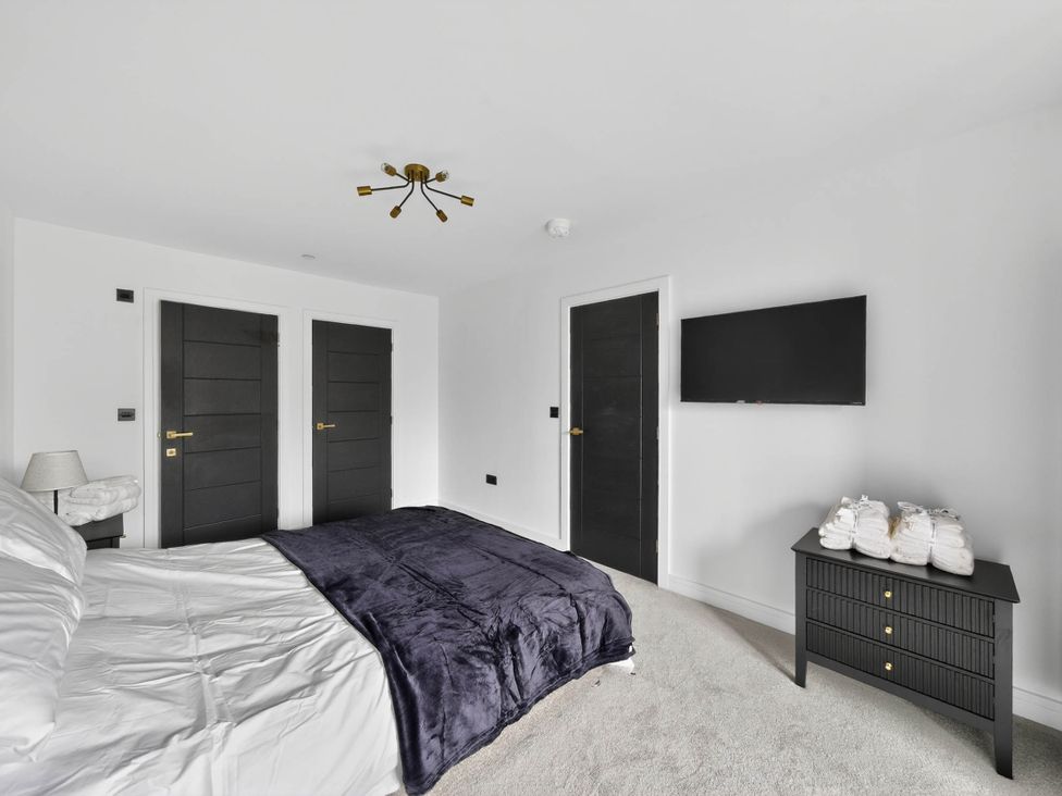 A bedroom with a bed and television at Ty Uchel