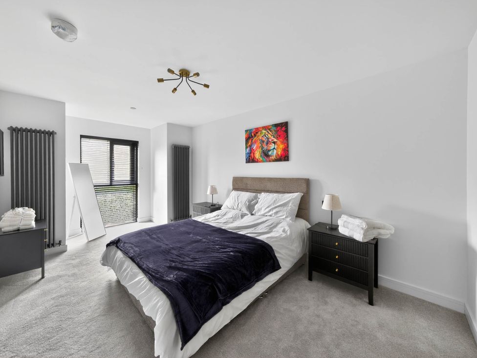 A bedroom with a bed and side tables at Ty Uchel