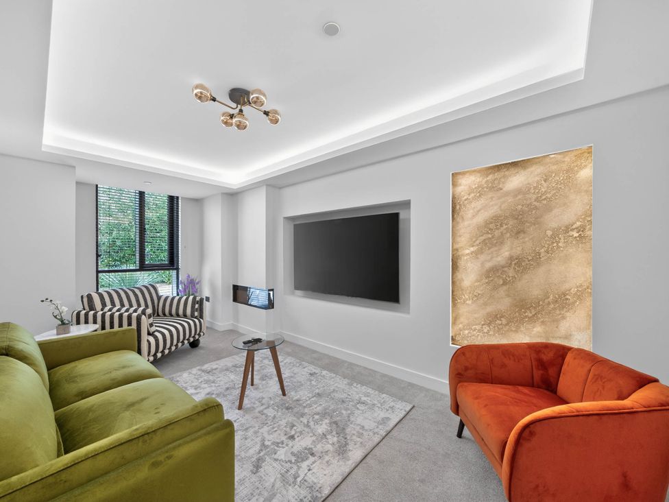 A living room with sofas and a television at Ty Uchel