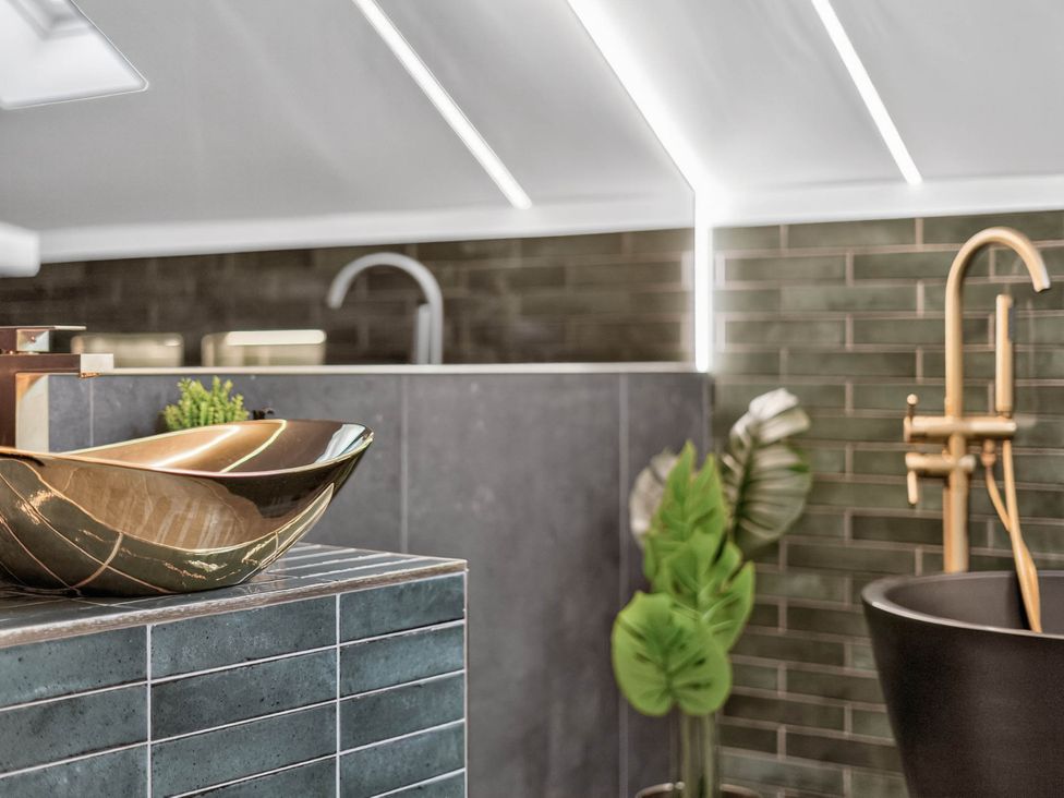 A bathroom with a sink and faucet at Ty Uchel