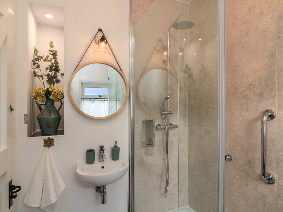 A bathroom with shower and sink at Ivy Cottage in Dartmouth
