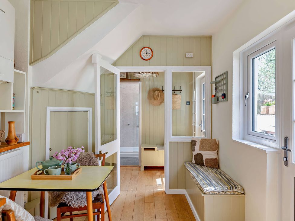 An indoor area with a table and chairs at Ivy Cottage in Dartmouth