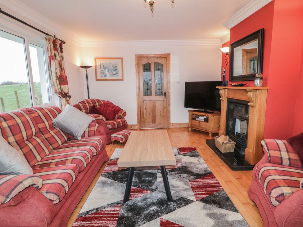 A living room with a sofa, coffee table, and fireplace at Bungalow Falcarragh, Falcarragh, County Donegal