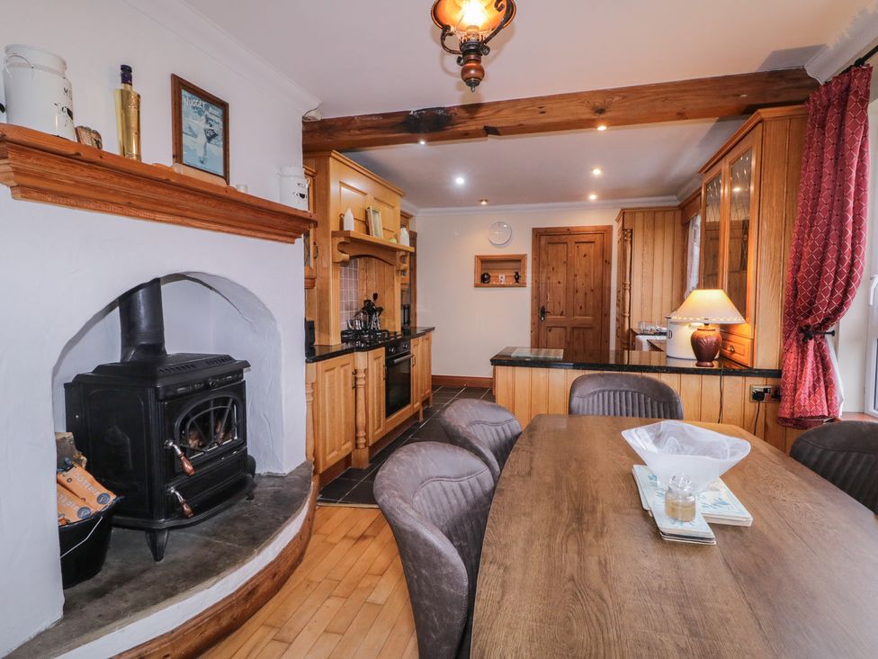 A kitchen with a stove and dining table at Bungalow Falcarragh, Falcarragh, County Donegal
