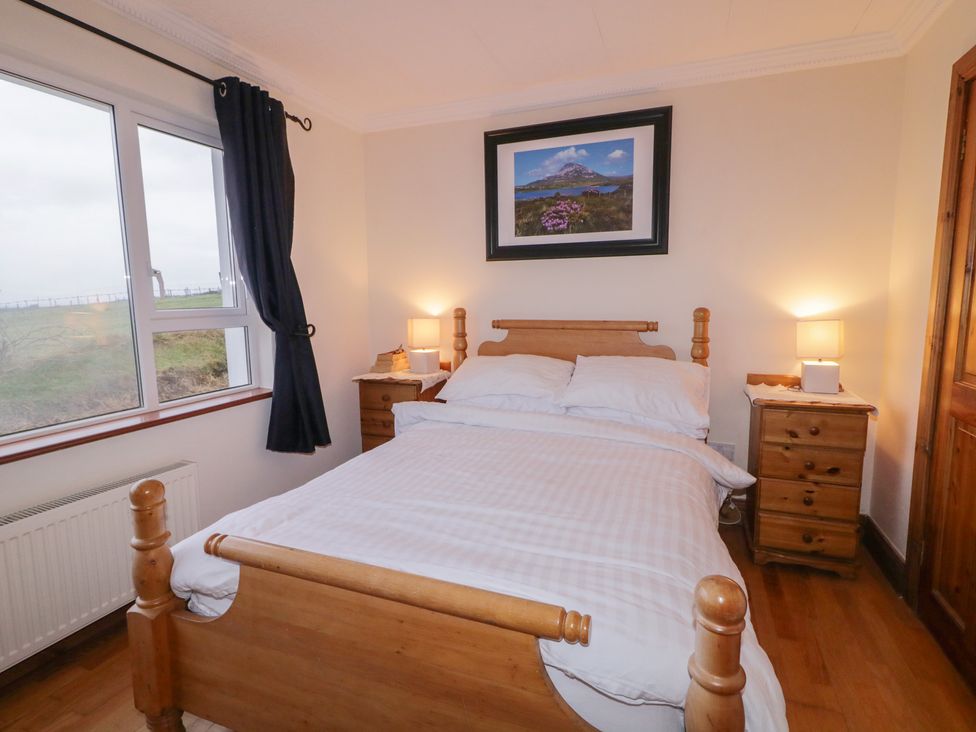 A bedroom with a bed and bedside tables at Bungalow Falcarragh, Falcarragh, County Donegal